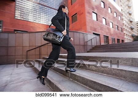 Businesswoman running up steps View Large Photo Image Stock Image - Businesswoman running up steps. Fotosearch