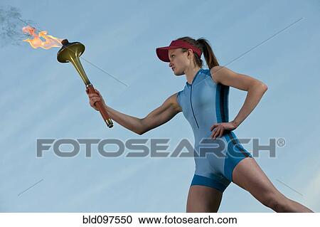 Caucasian athlete holding Olympic torch View Large Photo Image Stock Image - Caucasian athlete holding Olympic torch. Fotosearch
