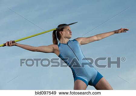 Stock Photo - Caucasian athlete throwing javelin. Fotosearch