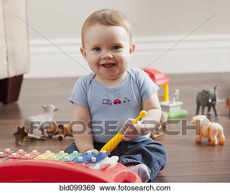 Caucasian baby boy playing with xylophone View Large Photo Image Stock Photo - Caucasian baby boy playing with xylophone. Fotosearch
