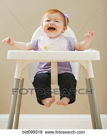 Caucasian baby girl crying in high chair View Large Photo Image Stock Photo - Caucasian baby girl crying in high chair. Fotosearch