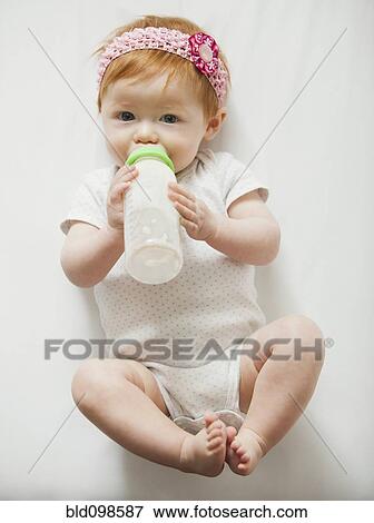 Caucasian baby girl drinking bottle View Large Photo Image Stock Photo - Caucasian baby girl drinking bottle. Fotosearch