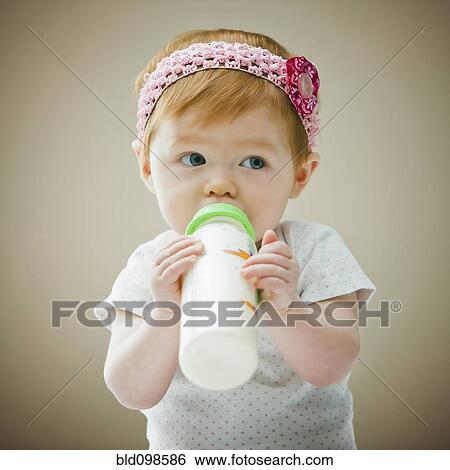 Caucasian baby girl drinking bottle View Large Photo Image Stock Photograph - Caucasian baby girl drinking bottle. Fotosearch