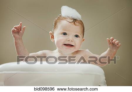 Stock Photograph - Caucasian baby girl having a bath. Fotosearch