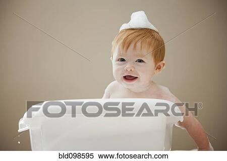 Stock Photography - Caucasian baby girl having a bath. Fotosearch