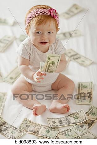 Caucasian baby girl playing with twenty dollar bills View Large Photo Image Stock Image - Caucasian baby girl playing with twenty dollar bills. Fotosearch