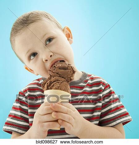 Caucasian boy eating ice cream cone View Large Photo Image Stock Photo - Caucasian boy eating ice cream cone. Fotosearch