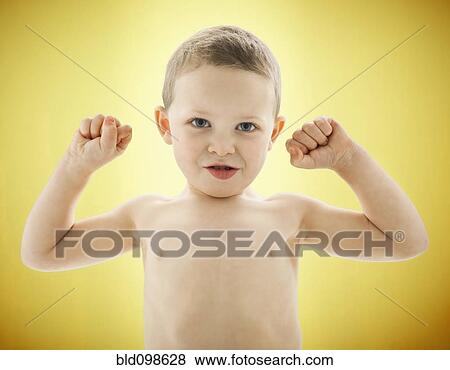 Stock Photo - Caucasian boy flexing his biceps. Fotosearch