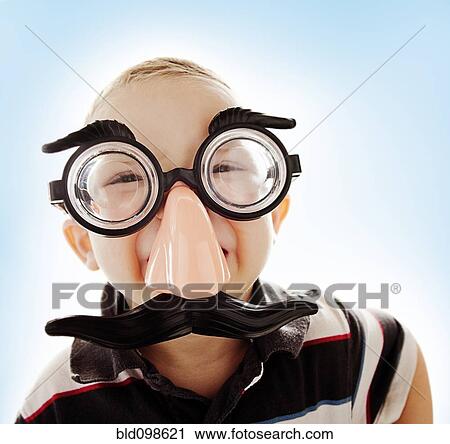 Stock Image - Caucasian boy in funny mustache mask. Fotosearch