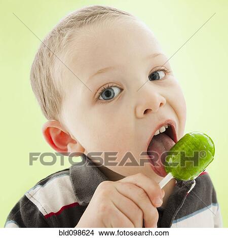 Caucasian boy licking lollipop View Large Photo Image Picture - Caucasian boy licking lollipop. Fotosearch