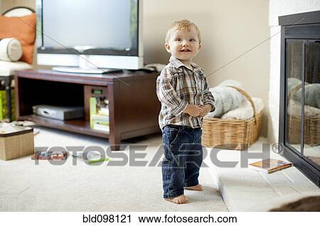 Caucasian boy standing in living room View Large Photo Image Stock Image - Caucasian boy standing in living room. Fotosearch