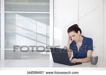 Caucasian businesswoman using laptop at desk View Large Photo Image Stock Photo - Caucasian businesswoman using laptop at desk. Fotosearch