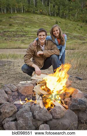 Caucasian couple enjoying campfire View Large Photo Image Stock Image - Caucasian couple enjoying campfire. Fotosearch