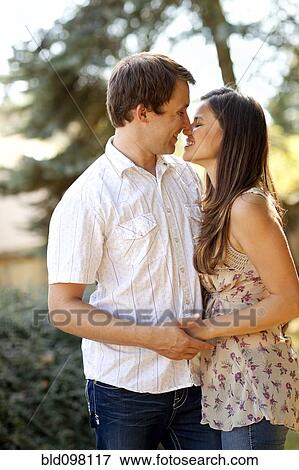 Caucasian couple kissing outdoors View Large Photo Image Stock Photo - Caucasian couple kissing outdoors. Fotosearch