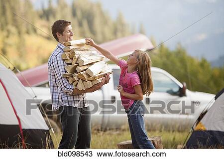 Caucasian father and daughter gathering firewood View Large Photo Image Stock Image - Caucasian father and daughter gathering firewood. Fotosearch