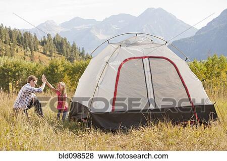 Caucasian father and daughter setting up tent View Large Photo Image Stock Photo - Caucasian father and daughter setting up tent. Fotosearch
