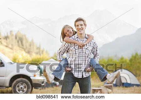 Caucasian father giving daughter piggy back ride View Large Photo Image Stock Image - Caucasian father giving daughter piggy back ride. Fotosearch