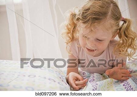 Caucasian girl laying in bed View Large Photo Image Stock Photograph - Caucasian girl laying in bed. Fotosearch