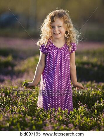 Stock Photography - Caucasian girl picking flowers. Fotosearch