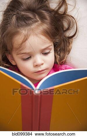 Picture - Caucasian girl reading a book. Fotosearch