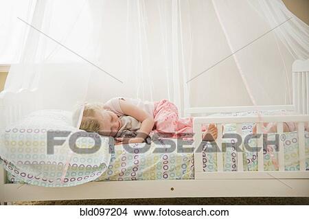 Picture - Caucasian girl sleeping in bed. Fotosearch