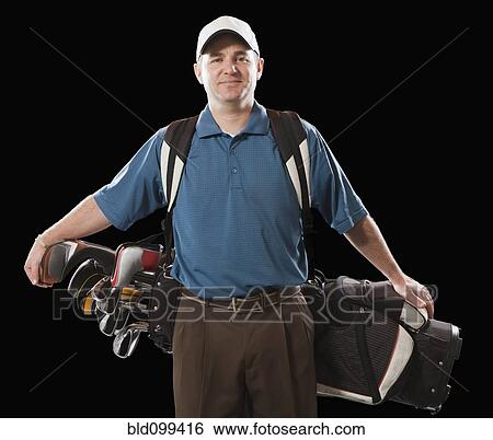 Stock Photograph - Caucasian golfer carrying golf bag. Fotosearch