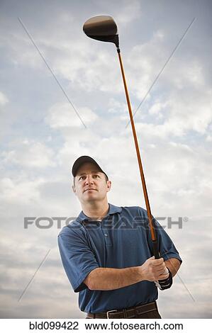 Stock Image - Caucasian golfer playing golf. Fotosearch