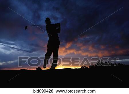 Caucasian golfer swinging golf club at sunset View Large Photo Image Stock Photo - Caucasian golfer swinging golf club at sunset. Fotosearch