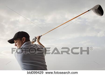 Caucasian golfer swinging golf club View Large Photo Image Stock Photo - Caucasian golfer swinging golf club. Fotosearch
