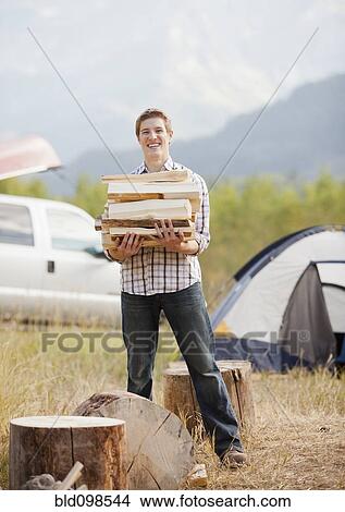 Picture - Caucasian man chopping firewood. Fotosearch