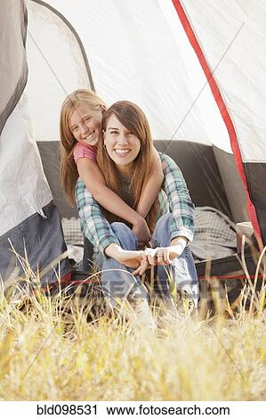 Stock Image - Caucasian mother and daughter camping together. Fotosearch