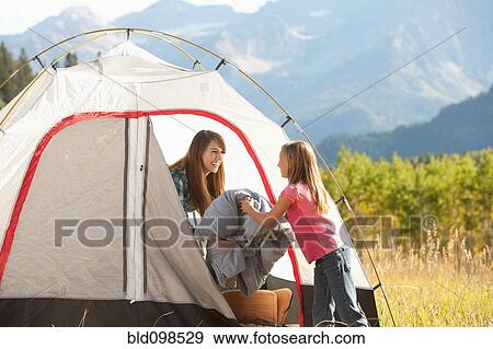 Stock Photo - Caucasian mother and daughter camping. Fotosearch