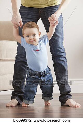 Caucasian mother helping son learn to walk View Large Photo Image Stock Image - Caucasian mother helping son learn to walk. Fotosearch