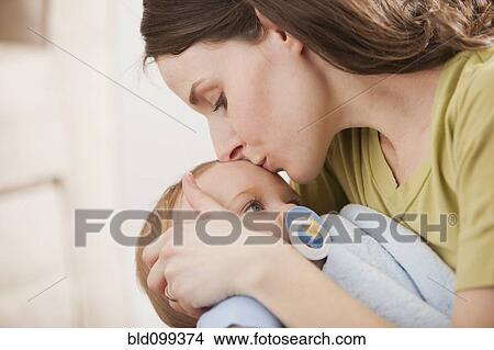 Picture - Caucasian mother kissing baby boy. Fotosearch