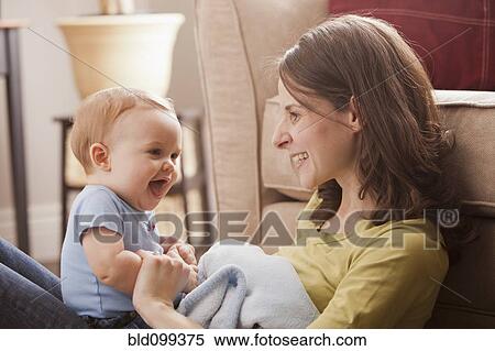 Stock Photography - Caucasian mother sitting with son in her lap. Fotosearch