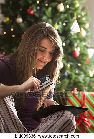 Caucasian woman Christmas shopping online with digital tablet View Large Photo Image Stock Photograph - Caucasian woman Christmas shopping online with digital tablet. Fotosearch