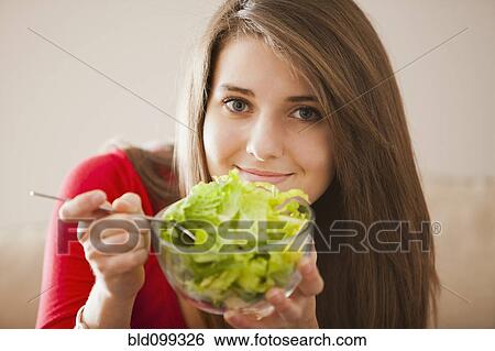 Caucasian woman eating salad View Large Photo Image Stock Photograph - Caucasian woman eating salad. Fotosearch
