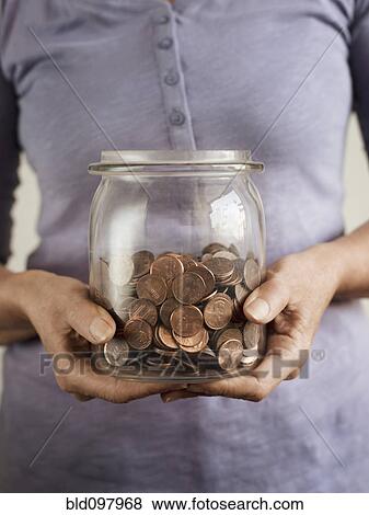 Caucasian woman holding jar of coins View Large Photo Image Stock Photo - Caucasian woman holding jar of coins. Fotosearch