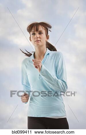 Stock Image - Caucasian woman jogging. Fotosearch