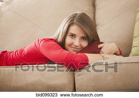 Caucasian woman laying on sofa View Large Photo Image Stock Image - Caucasian woman laying on sofa. Fotosearch