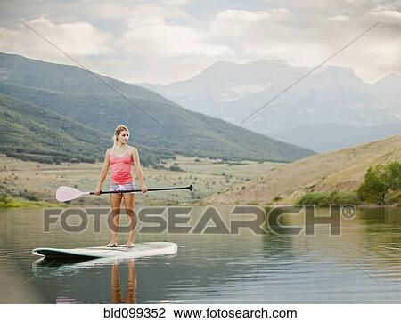 Caucasian woman on stand up paddle board View Large Photo Image Stock Image - Caucasian woman on stand up paddle board. Fotosearch