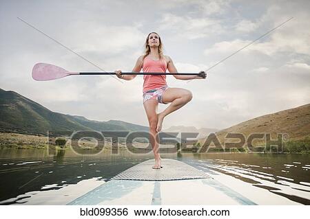 Caucasian woman on stand up paddle board View Large Photo Image Stock Photograph - Caucasian woman on stand up paddle board. Fotosearch