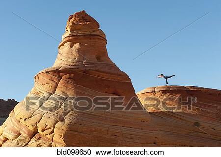 Stock Image - Caucasian woman practicing yoga outdoors. Fotosearch