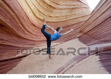 Stock Image - Caucasian woman practicing yoga outdoors. Fotosearch