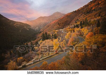 Stock Photography - Caucasian woman running along autumn road. Fotosearch