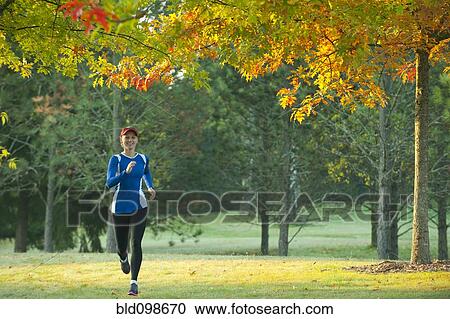 Caucasian woman running in park View Large Photo Image Stock Image - Caucasian woman running in park. Fotosearch