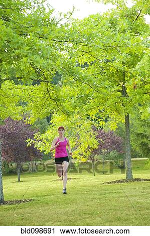 Caucasian woman running in park View Large Photo Image Stock Image - Caucasian woman running in park. Fotosearch