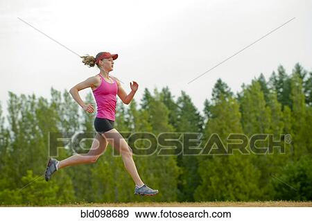 Stock Photo - Caucasian woman running in park. Fotosearch
