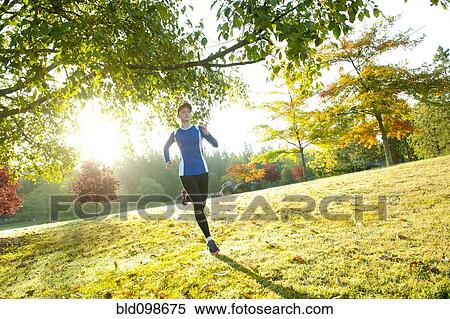 Caucasian woman running in park View Large Photo Image Stock Photography - Caucasian woman running in park. Fotosearch