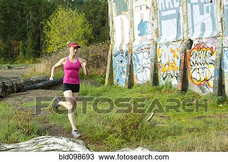 Caucasian woman running near abandoned building View Large Photo Image Stock Image - Caucasian woman running near abandoned building. Fotosearch